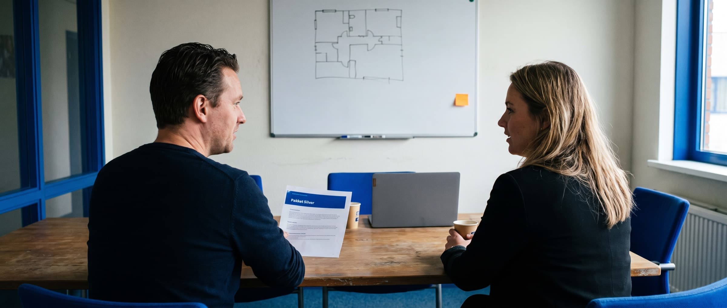 Accountmanager van een servicebedrijf en een klant aan een vergadertafel met een uitgeprinte offerte tussen hen in